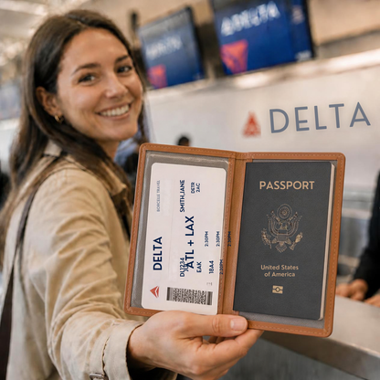 Smiling traveler holding an open passport and boarding pass wallet at an airport check-in counter